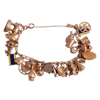 Lot 290 - A gold charm bracelet with twenty-eight charms attached.