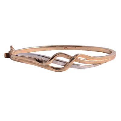 Lot 269 - A 9 carat yellow and white gold half-hinged bangle.