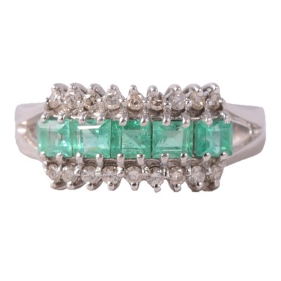 Lot 5 - An emerald and diamond half hoop ring.