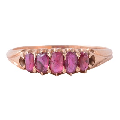 Lot 19 - A five stone ruby half hoop ring.