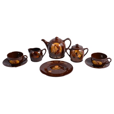 Lot 40 - Royal Doulton, a Kingsware 'The Cup that Cheers' tea-for-two