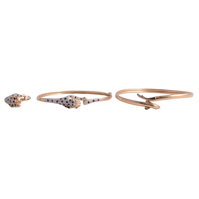 Lot 277 - Two modern yellow metal bangles, panther and dolphin, and a panther ring.