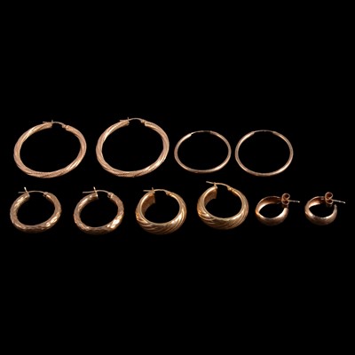 Lot 451 - Five pairs of 9 carat yellow gold and yellow metal hoop earrings.