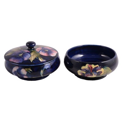 Lot 3 - Moorcroft Pottery, a 'Pansy' pattern dish and cover, and a 'Hibiscus' dish