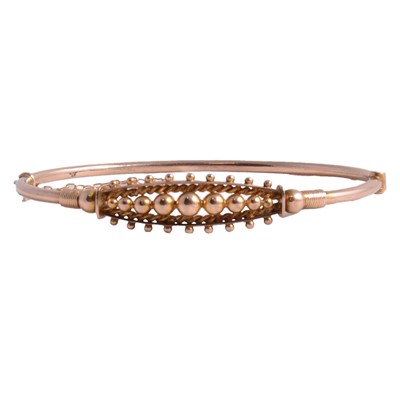 Lot 262 - A yellow metal half hinged bangle.