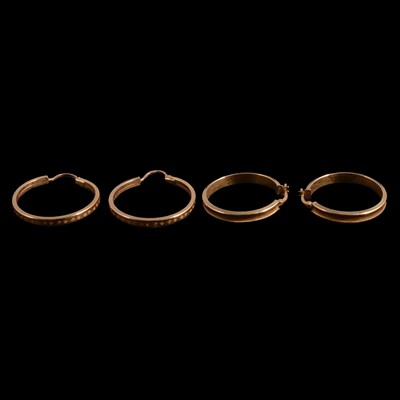 Lot 450 - Two pairs of yellow metal hoop earrings.