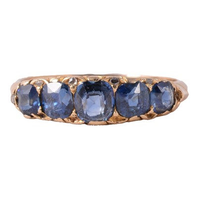 Lot 55 - A sapphire half hoop ring.