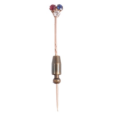 Lot 297 - A diamond, ruby, and sapphire stick pin.