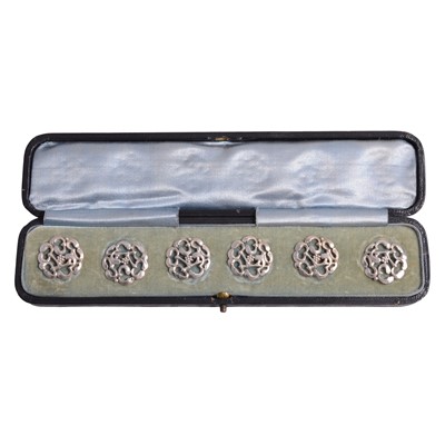 Lot 1217 - A set of six silver Art Nouveau buttons, cased.