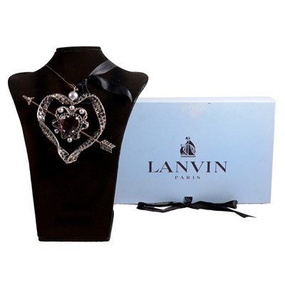 Lot 1195 - Lanvin - a heart and arrow pendant with ribbon necklace, cased.
