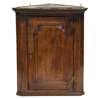 Lot 339 - George III oak hanging corner cupboard