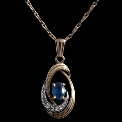 Lot 369 - Two sapphire pendants on chains.