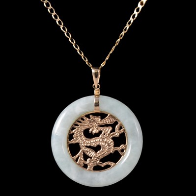 Lot 379 - A gold and green jade dragon pendant on a chain.