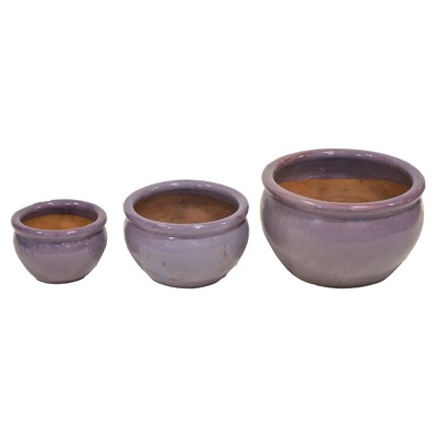 Lot 436 - Set of three graduating lilac glazed terracotta planters