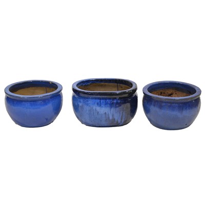 Lot 435 - Pair of blue glazed terracotta planters and a similar oval planter