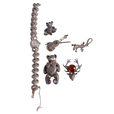 Lot 1254 - Five marcasite and paste set white metal brooches, and a silver and marcasite wristwatch.