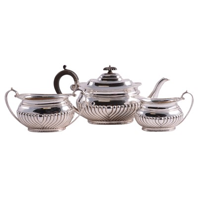 Lot 258 - Three piece silver tea service, Sheffield 1920, Queen Anne half fluted style