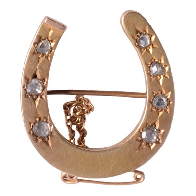 Lot 242A - A diamond horseshoe brooch.