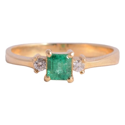 Lot 9 - An emerald and diamond ring.