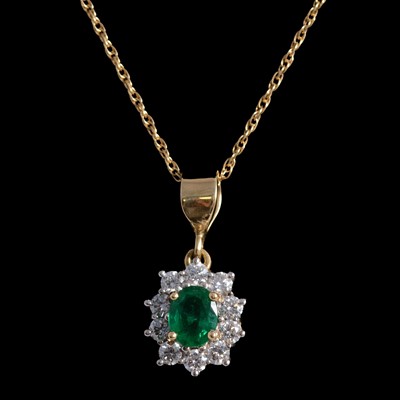 Lot 373 - An emerald and diamond pendant on a chain.