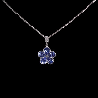 Lot 422 - A tanzanite and diamond floral pendant on a chain.