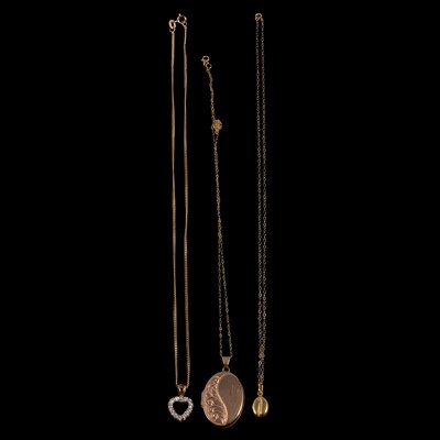 Lot 412 - Seven 9 carat yellow gold / yellow metal pendants on chains.