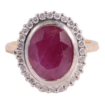 Lot 17 - A ruby and diamond cluster ring.
