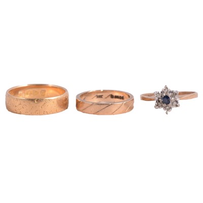 Lot 137 - Two gold wedding bands, and a sapphire and diamond ring.