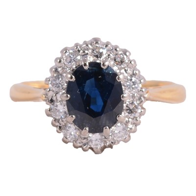 Lot 44 - A sapphire and diamond cluster ring.