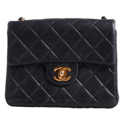 Lot 1175 - Chanel - a navy quilted cross shoulder mini leather flap bag with registration card.