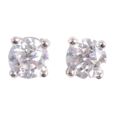 Lot 424 - A pair of diamond earstuds.