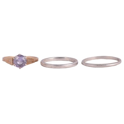 Lot 126 - A synthetic alexandrite ring, platinum wedding band, and white metal wedding band.