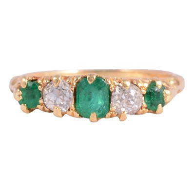 Lot 7 - An emerald and diamond ring.