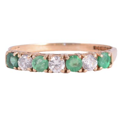 Lot 13 - An emerald and cubic zirconia half hoop ring.