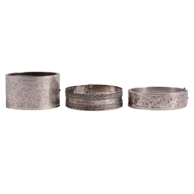Lot 1237 - Three white metal bangles.
