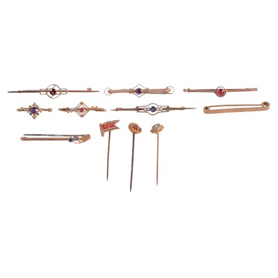 Lot 258 - A collection of yellow metal bar brooches and stick pins, some gemset.
