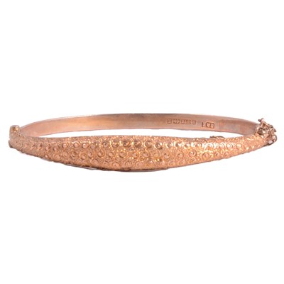 Lot 263 - A 9 carat yellow gold half-hinged bangle.