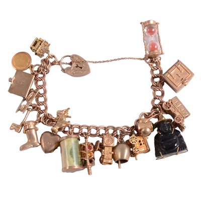 Lot 293 - A 9 carat yellow gold charm bracelet with charms attached.
