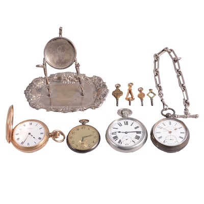 Lot 1041 - A gold-plated demi-hunter pocket watch, three others, a silver-plated watch stand, and watch keys.