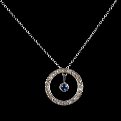 Lot 401 - A sapphire and diamond circular pendant.