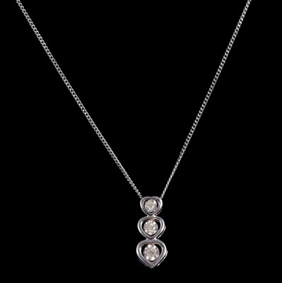 Lot 395 - A diamond triple heart pendant.