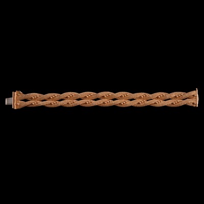 Lot 307 - A yellow metal four strand woven bracelet.