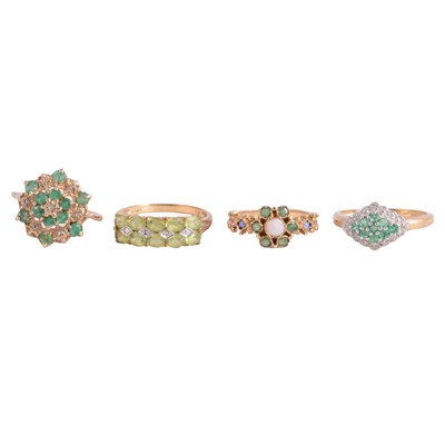 Lot 15 - Four gemstone rings, emerald and diamond, peridot and diamond, and another.