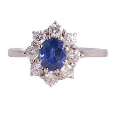Lot 20 - A sapphire and diamond cluster ring.