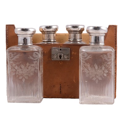 Lot 80 - Set of four engraved glass flasks, with silver covers