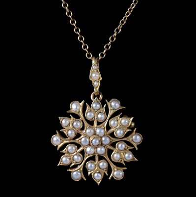 Lot 351 - An Edwardian seed pearl pendant / brooch on a chain.