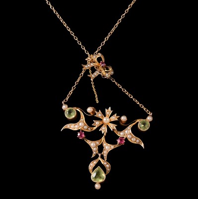 Lot 348 - An Edwardian peridot and seed pearl pendant and chain.