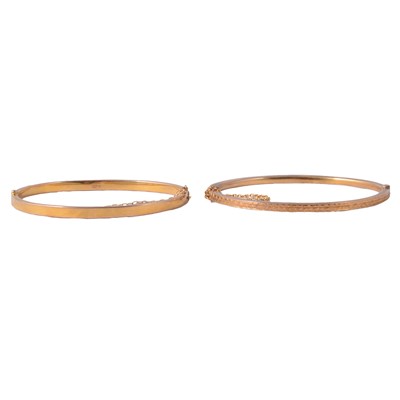 Lot 237 - A 9 carat yellow gold bangle and another similar unmarked bangle.