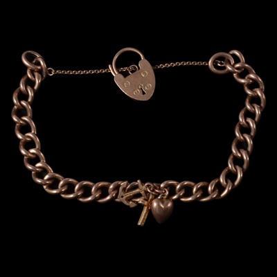 Lot 258 - A rose metal curb link bracelet with padlock fastener and charm.