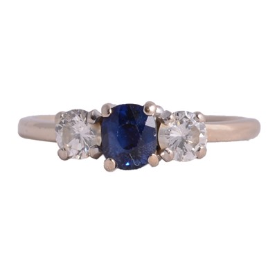 Lot 22 - A sapphire and diamond three stone ring.